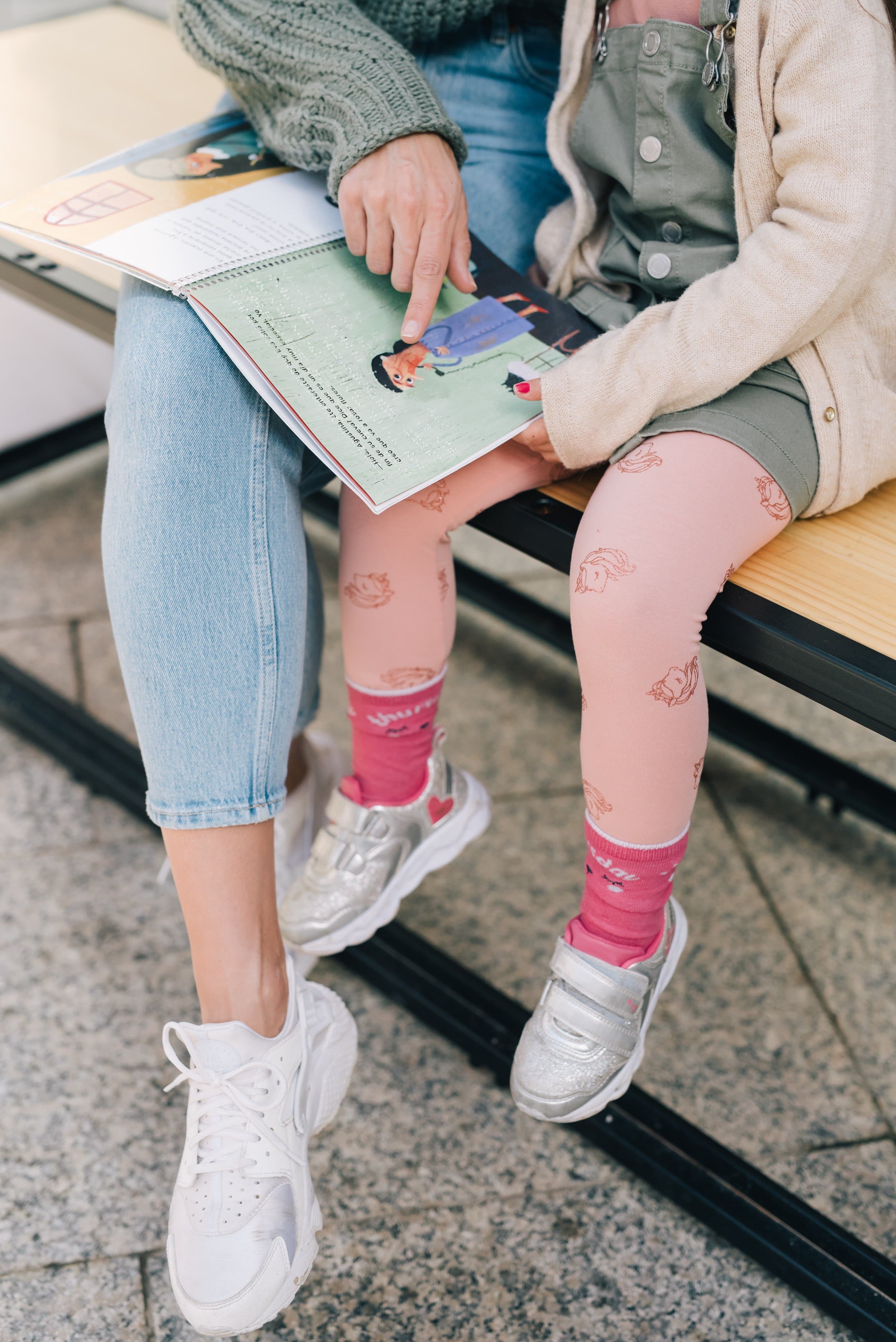 Therapist or parent reading a children’s book with a young child during a speech and language learning session.